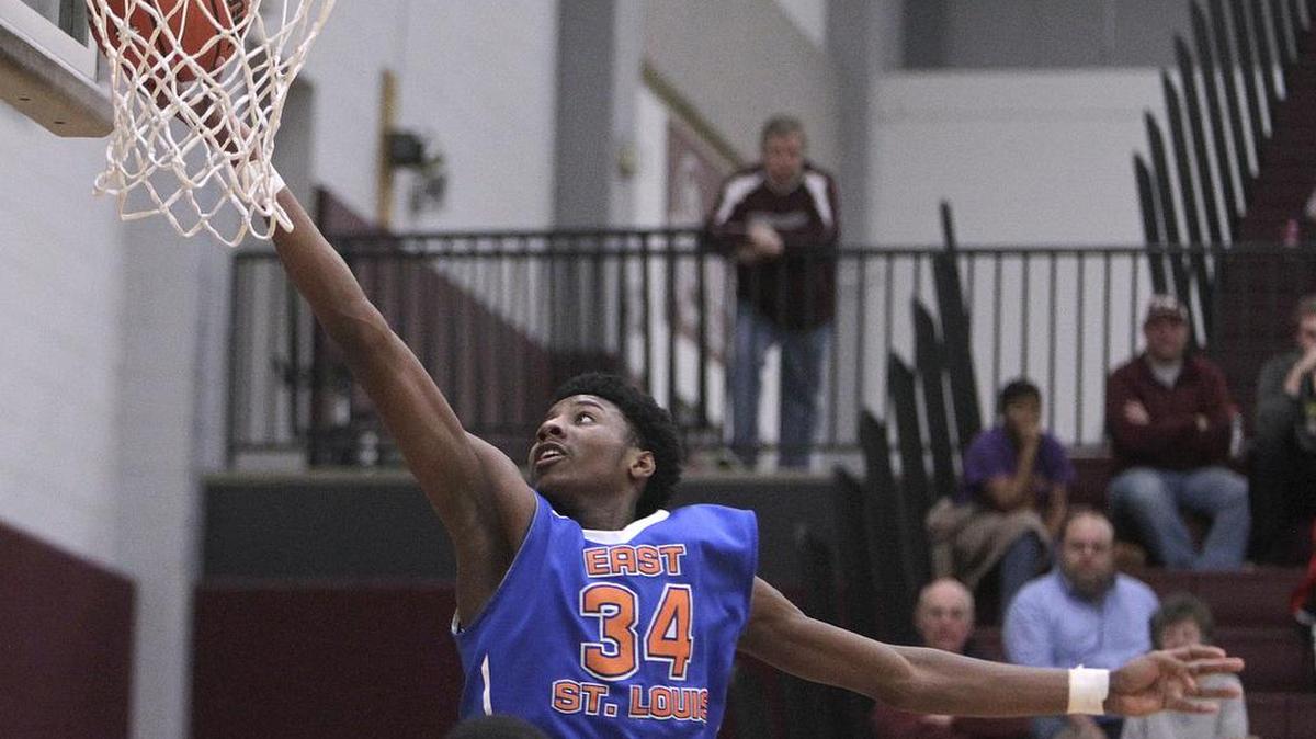 East St. Louis player Terrence Hargrove takes the ball into the basket in first half action.