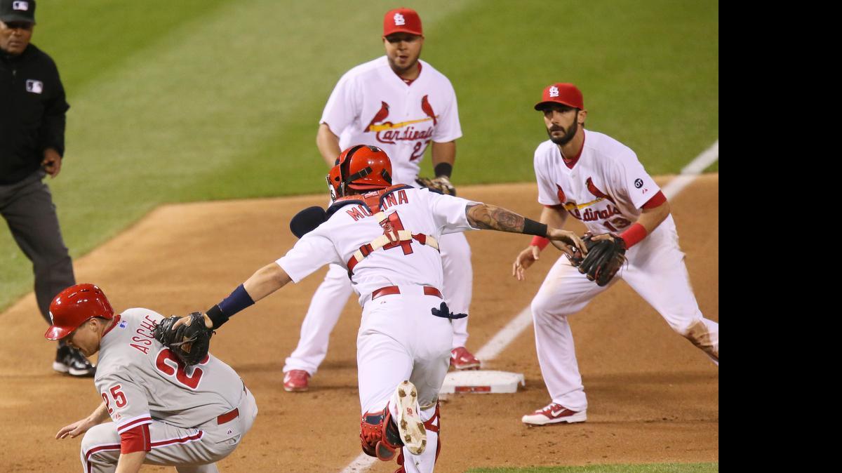 
Philadelphia’s Cody Asche is tagged out by St. Louis’ catcher Yadier Molina in a run down between third and home in the seventh inning during the game between the Cardinals and the Phillies on Monday at Busch Stadium in St. Louis.
