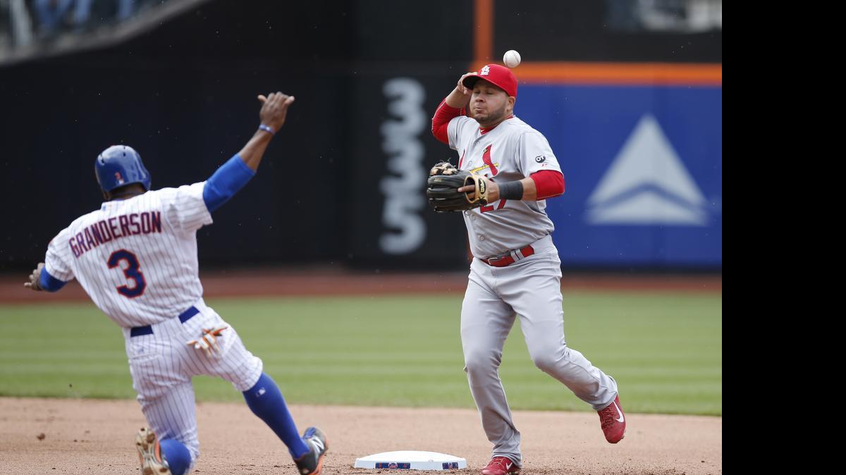 
Cardinals shortstop Jhonny Peralta loses the ball trying to complete a double play after forcing out the Mets’ Curtis Granderson during the eighth inning Thursday in New York. The Mets’ Juan Lagares hit into the double play. New York won 5-0, forcing a split of the four-game series.




