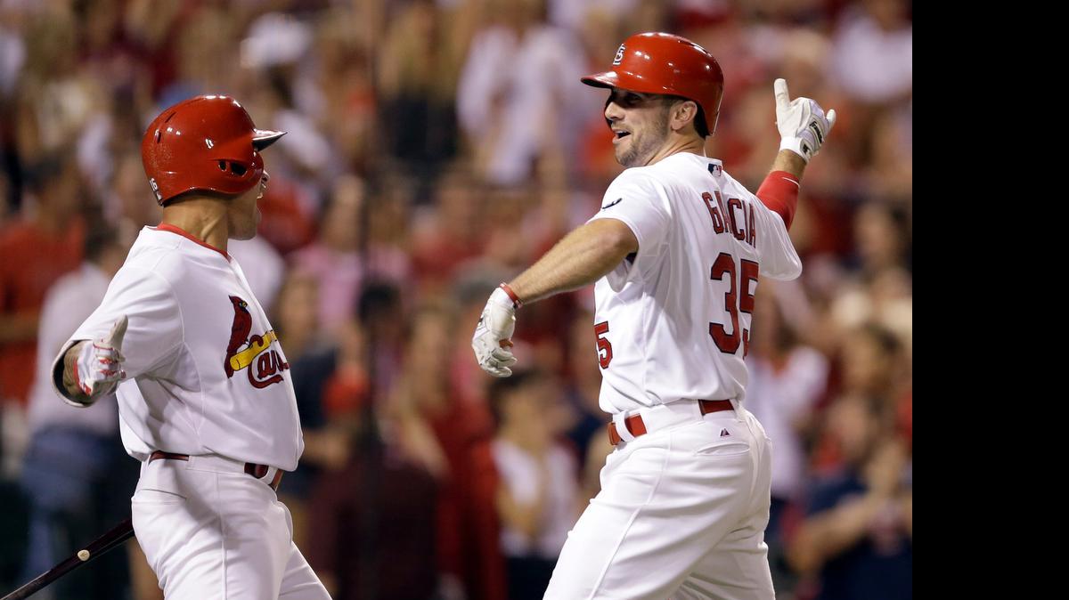 
The Cardinals' Greg Garcia is congratulated by teammate Kolten Wong after hitting a solo home run during the eighth inning Friday against the Cubs at Busch Stadium. The Cardinals won 2-1 in 10 innings.


