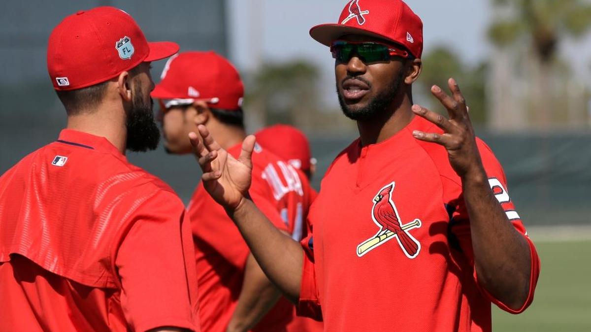 The St. Louis Cardinals’ Dexter Fowler is shown talking with Matt Carpenter during a spring training baseball workout in Jupiter, Fla. Fowler previously played for the World Series champion Chicago Cubs. The Cubs and the Cardinals open the 2017 season Sunday night at Busch Stadium.