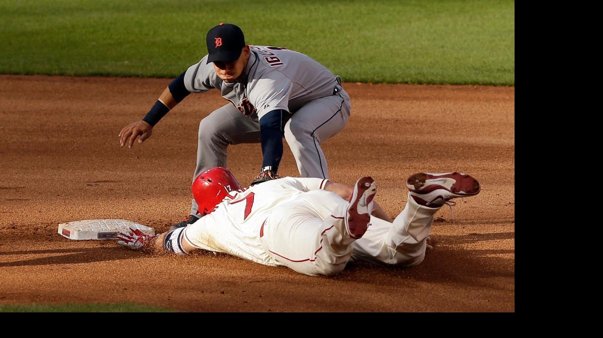 
The Cardinals’ Matt Holliday is tagged out by Tigers shortstop Jose Iglesias as he tries to stretch a single to a double during the 10th inning Saturday at Busch Stadium. Detroit won 4-3.
