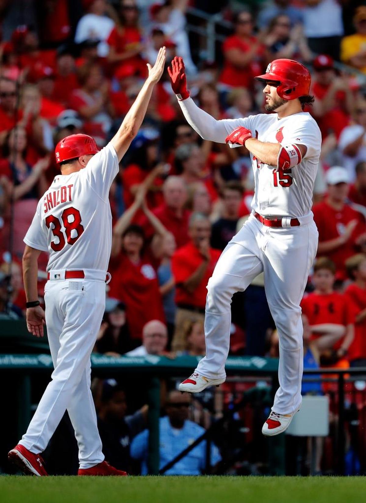 St. Louis Cardinals' Randal Grichuk, right, is congratulated by third base coach Mike Shildt after hitting a solo home run during the seventh inning of a baseball game against the Milwaukee Brewers Sunday, Oct. 1, 2017, in St. Louis.