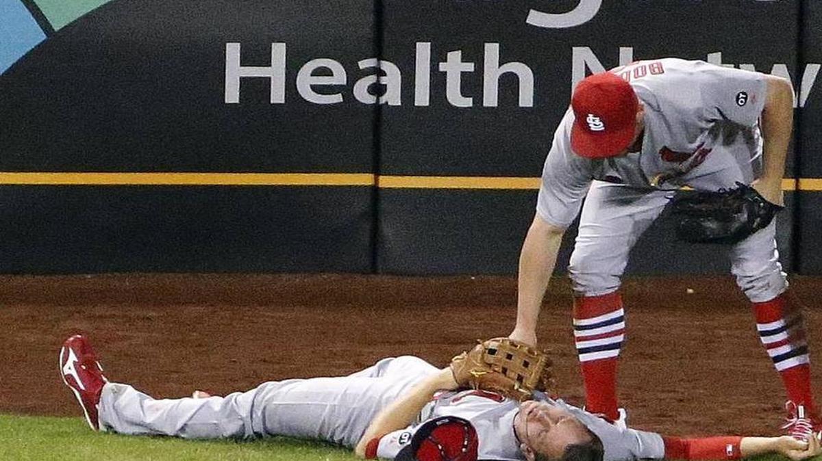 
Stephen Piscotty is motionless while teammate Peter Bourjos tends to him after they collided in the seventh inning Monday night.
