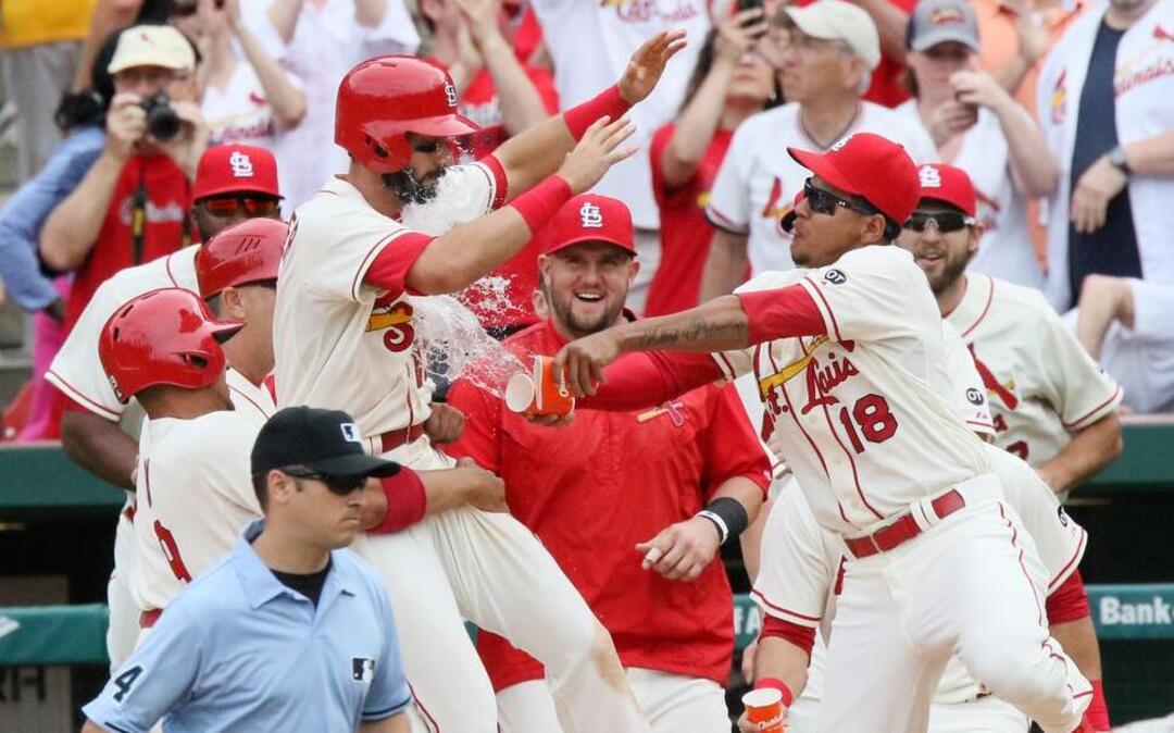 
The Cardinals’ Matt Carpenter is doused with water after his sacrifice fly drove in Pete Kozma in the 11th inning against the Pirates on Saturday at Busch Stadium. The Cardinals won 2-1, a day after they had defeated Pittsburgh by an identical score in annother 11-inning game




