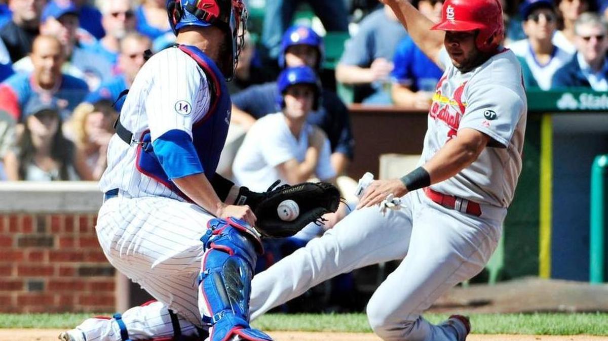 
The Cardinals’ Jhonny Peralta slides into an out at home plate during an August game at Wrigley Field.
