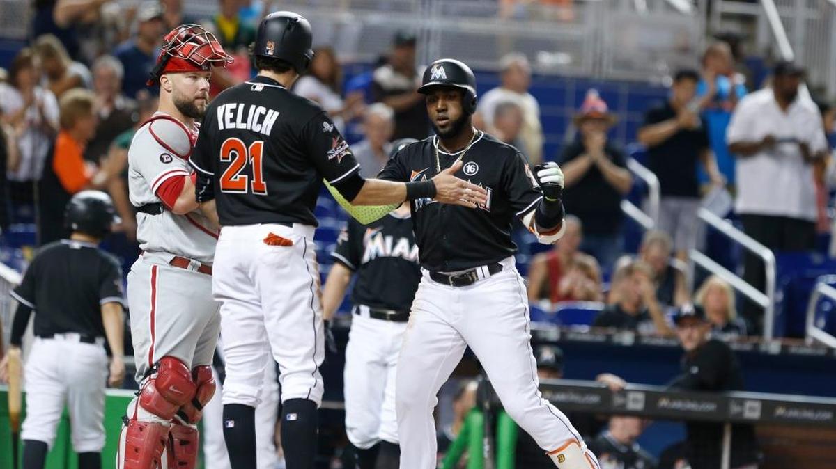 Christian Yelich celebrates with now former teammate Marcell Ozuna during a game in September. The Cardinals have already added Ozuna to their roster. Should they try to add Yelich, too, even if it means Tommy Pham goes to the bench?