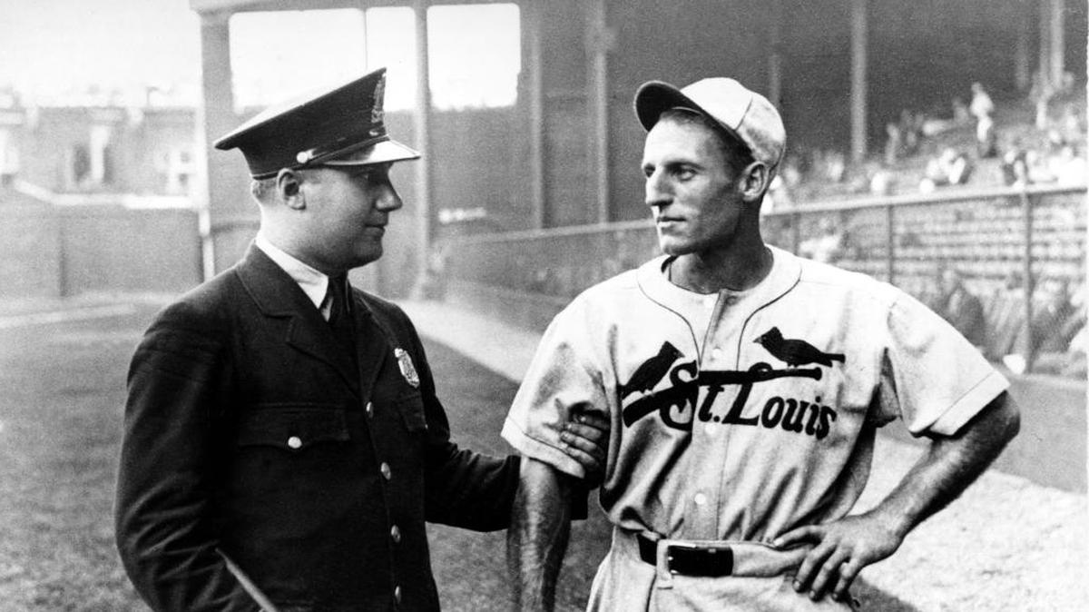 Pepper Martin, the fast running rookie of the St. Louis Cardinals, plays along as a policeman pretends to reprimand Martin for speeding before Game 3 of the World Series against the Philadelphia Athletics at Shibe Park in Philadelphia, Pa., on Oct. 5, 1931. Martin had seven career stolen bases in his Fall Classic career.