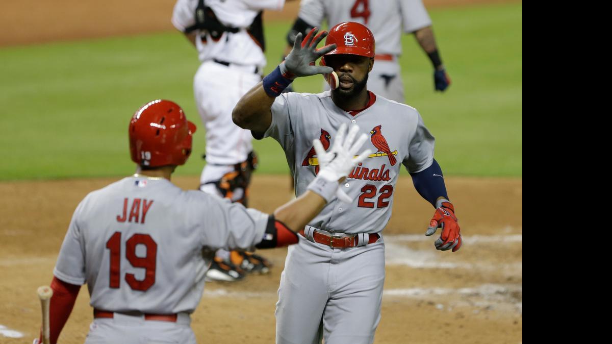 
The Cardinals’ Jason Heyward is congratulatd by Jon Jay after hitting a three-run home run off the Marlins’ Mat Latos during the fourth inning Wednesday in Miami. The Cardinals won 6-1.
