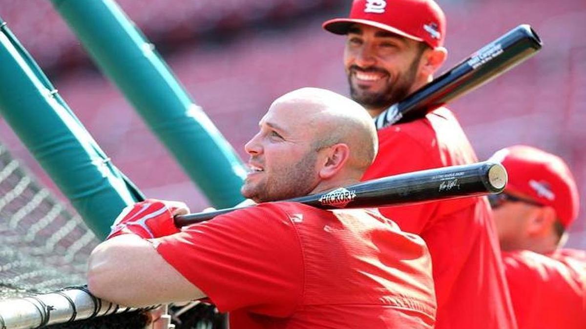 Matt Holliday and Matt Carpenter visit outside the batting cage at Busch Stadium in 2016.