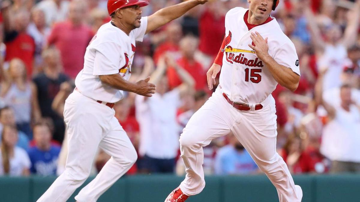 Randal Grichuk runs past St. Louis’ third base coach Jose Oquendo during a game last season. Oquendo will not return to the St. Louis Cardinals this season. He said Saturday that he will have right knee-replacement surgery within the next month in Florida. The recovery period is about six months.