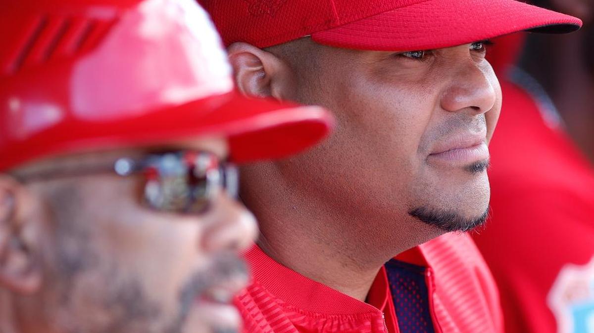 Brayan Pena, right, sits with longtime Cardinals coach Jose Oquendo in the team’s dugout during a spring training game. Pena is expected to serve as Gold Glover catcher Yadier Molina’s top backup during the season.