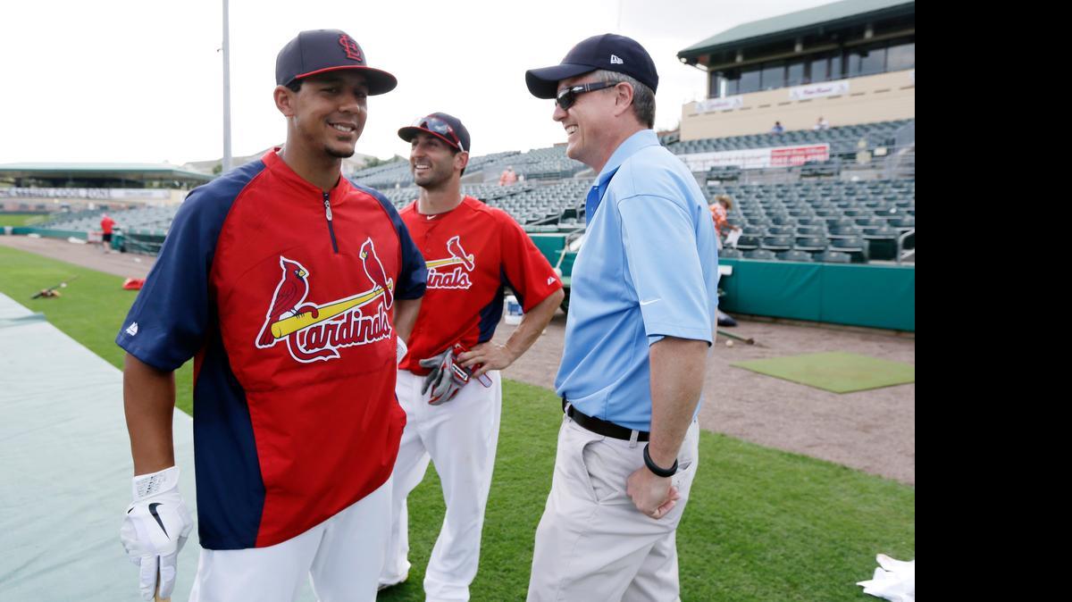 
In this 2013 file photo, Houston Astros general manager Jeff Luhnow, right, talks to St. Louis Cardinals center fielder Jon Jay, left, and second baseman Daniel Descalso before an exhibition spring training baseball game in Jupiter, Fla.
