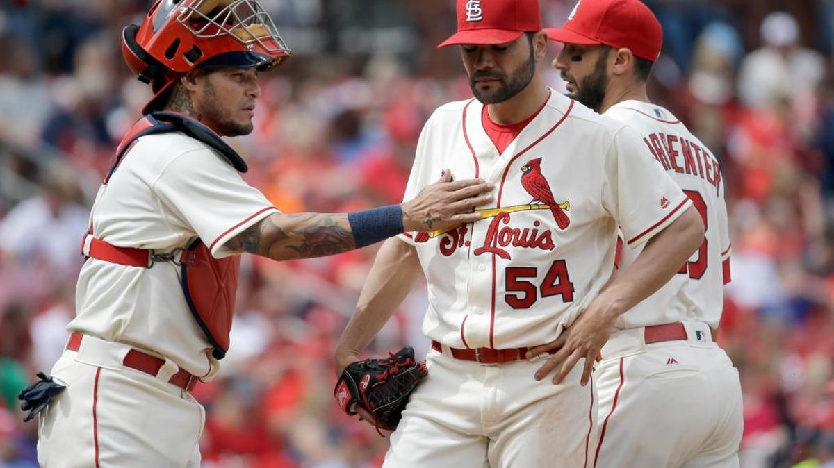 St. Louis Cardinals starting pitcher Jaime Garcia gets a pat from catcher Yadier Molina before being pulled out of a baseball game against the Washington Nationals as teammate Matt Carpenter walks by during the seventh inning of the game Saturday in St. Louis.
