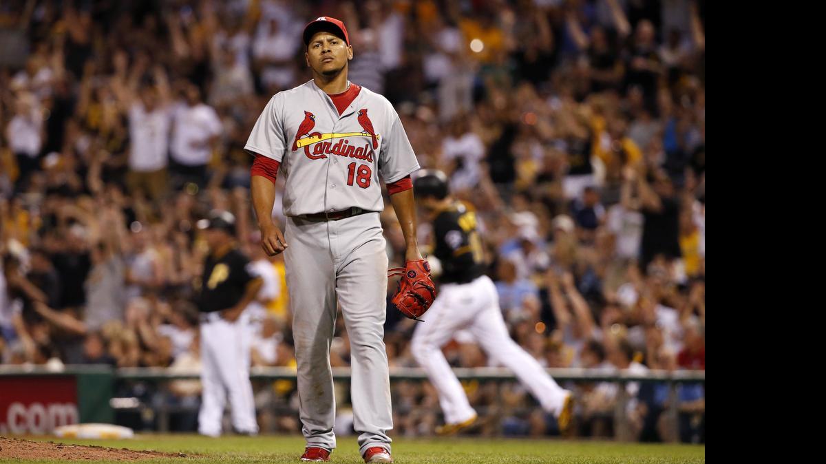 
St. Louis Cardinals starting pitcher Carlos Martinez (18) waits as Pittsburgh Pirates' Neil Walker, right rear, rounds first after hitting a solo-home run off St. Louis Cardinals starting pitcher Carlos Martinez in the fifth inning of a baseball game in Pittsburgh, Saturday, May 9, 2015. (AP Photo/Gene J. Puskar)
Cardinals pitcher Carlos Martinez waits as the Pirates’ Neil Walker rounds the bases after hitting a solo home run during the fifith inning Saturday in Pittsburgh. The Pirates defeated the Cardinals 7-5.
