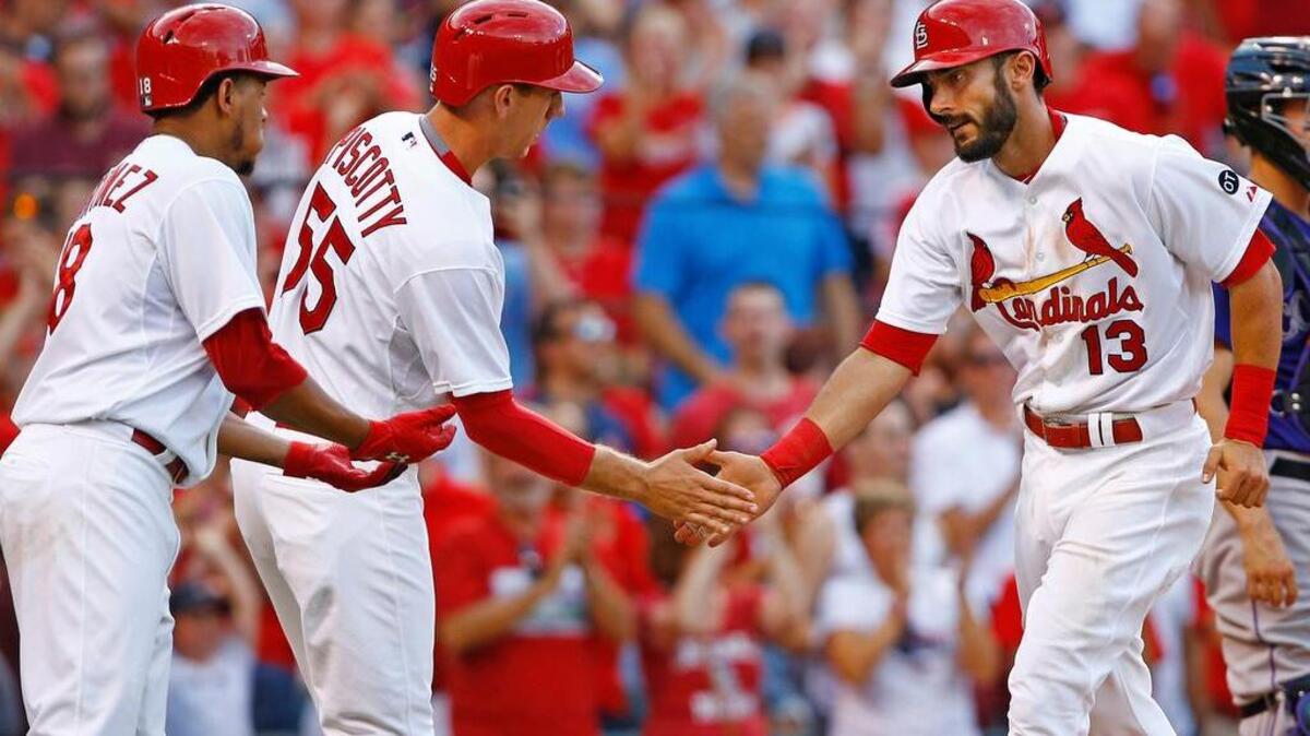 
The Cardinals' Matt Carpenter is congratulated by Stephen Piscotty, left, and Carlos Martinez after hitting a three-run home runoff the Rockies' Chris Rusin during the second inning Thursday at Busch Stadium. Carpenter homered twice in the Cardinals' 9-8 victory.
