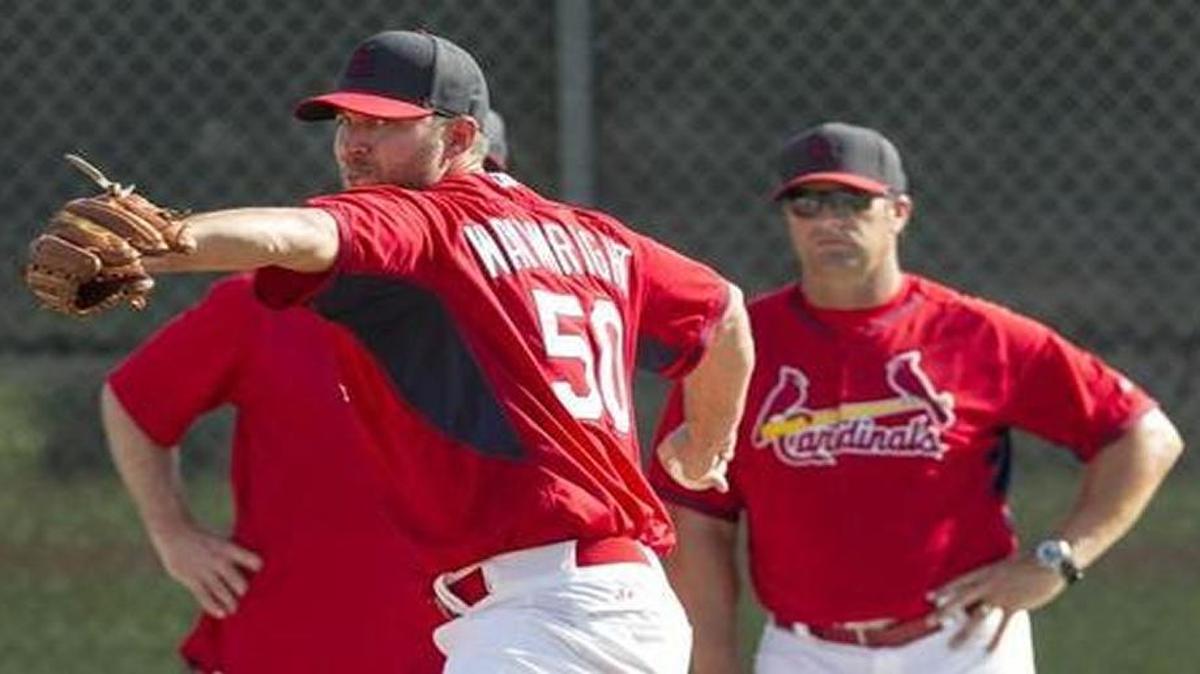 In a BND file photo, Adam Wainwright throws a bullpen session as manager Mike Matheny looks on.
