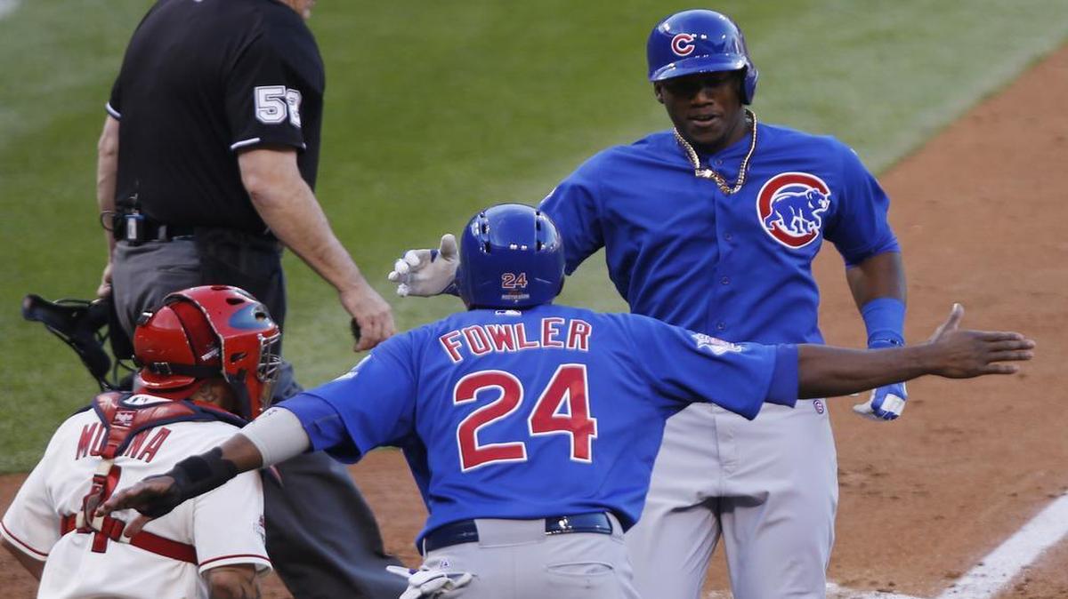 
Chicago Cubs' Dexter Fowler and teammate Jorge Soler celebrate as they score on Soler's home run during the second inning of game 2 of the NLDS against the St. Louis Cardinals on Saturday.
