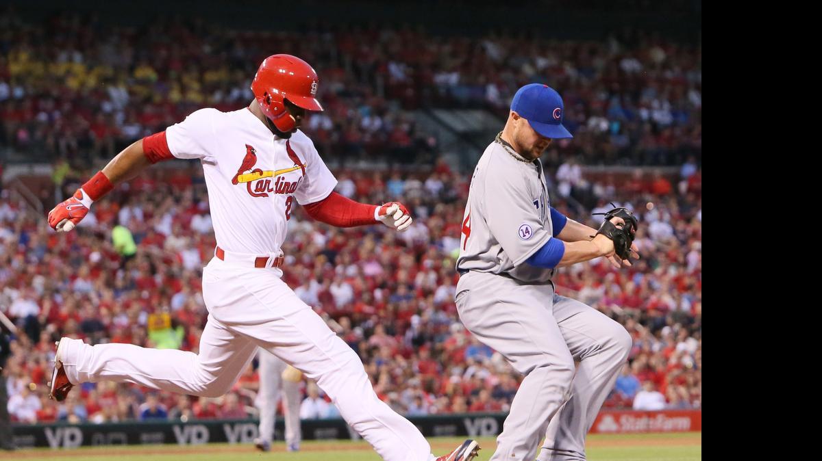
The St. Louis Cardinals' Jason Heyward, left, reaches safely as Chicago Cubs pitcher Jon Lester is unable to catch the ball while covering first in the second inning Wednesday night.
