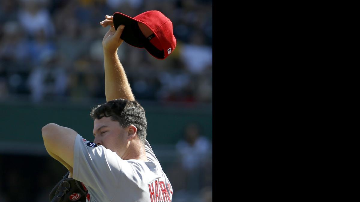 
 Cardinals relief pitcher Mitch Harris wipes his face after giving up a hit to Pittsburgh Pirates' Jung Ho Kang that drove in the go-ahead run during the seventh inning Sunday in Pittsburgh. The Pirates defeated the Cardinals 4-3.
