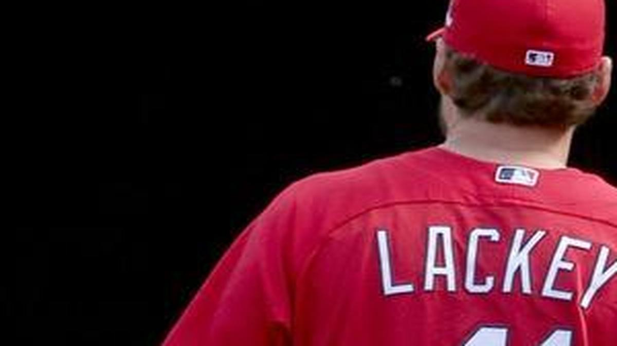 
St. Louis’ starting pitcher John Lackey and his son Carter, 6, walk to the outfield during the Cardinals’ workout Thursday in preparation for facing the Chicago Cubs on Friday.
