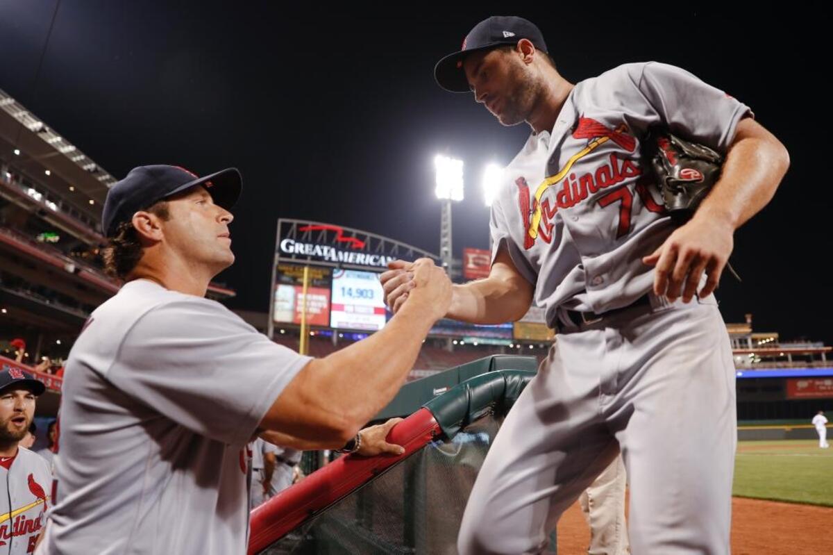 St. Louis Cardinals manager Mike Matheny, left, congratulates relief pitcher Tyler Lyons, right, after Lyons closes the eighth inning of a baseball game against the Cincinnati Reds, Thursday, Sept. 21, 2017, in Cincinnati.