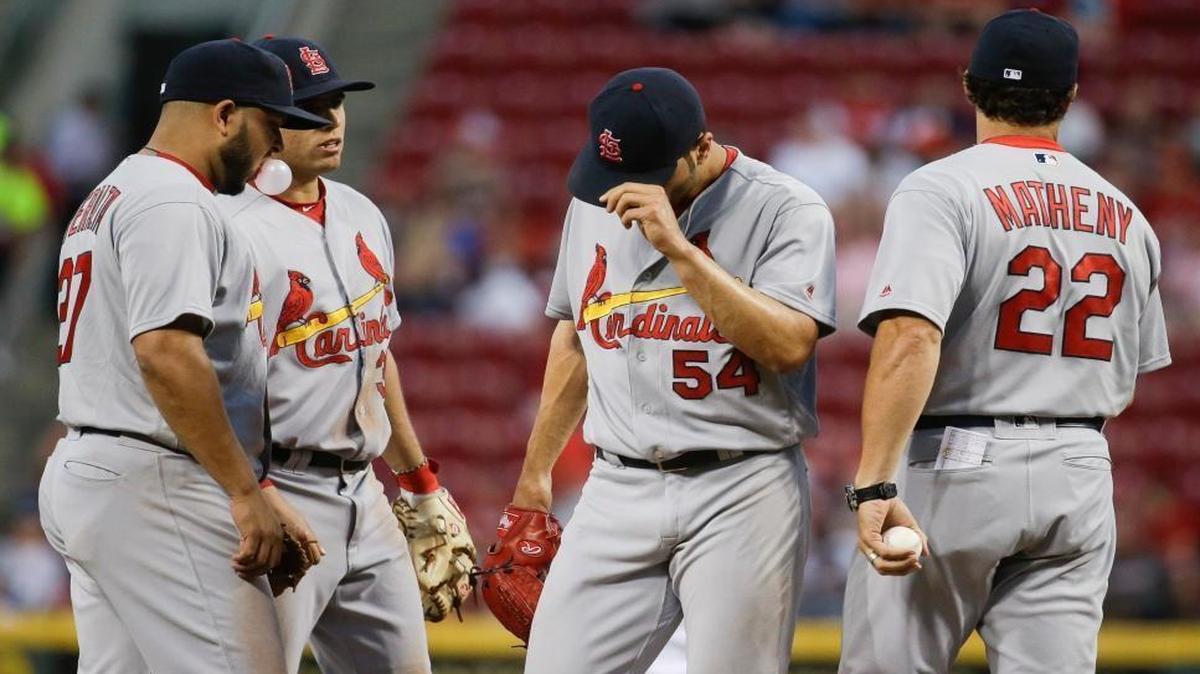 St. Louis Cardinals manager Mike Matheny takes the ball from starting pitcher Jaime Garcia (54) as he is removed during the fifth inning of the Cardinals game Wednesday in Cincinnati. Jhonny Peralta, left, and Aledmys Diaz look on as Matheny lifts Garcia, who allowed five runs on 13 hits in 4 2/3 innings.