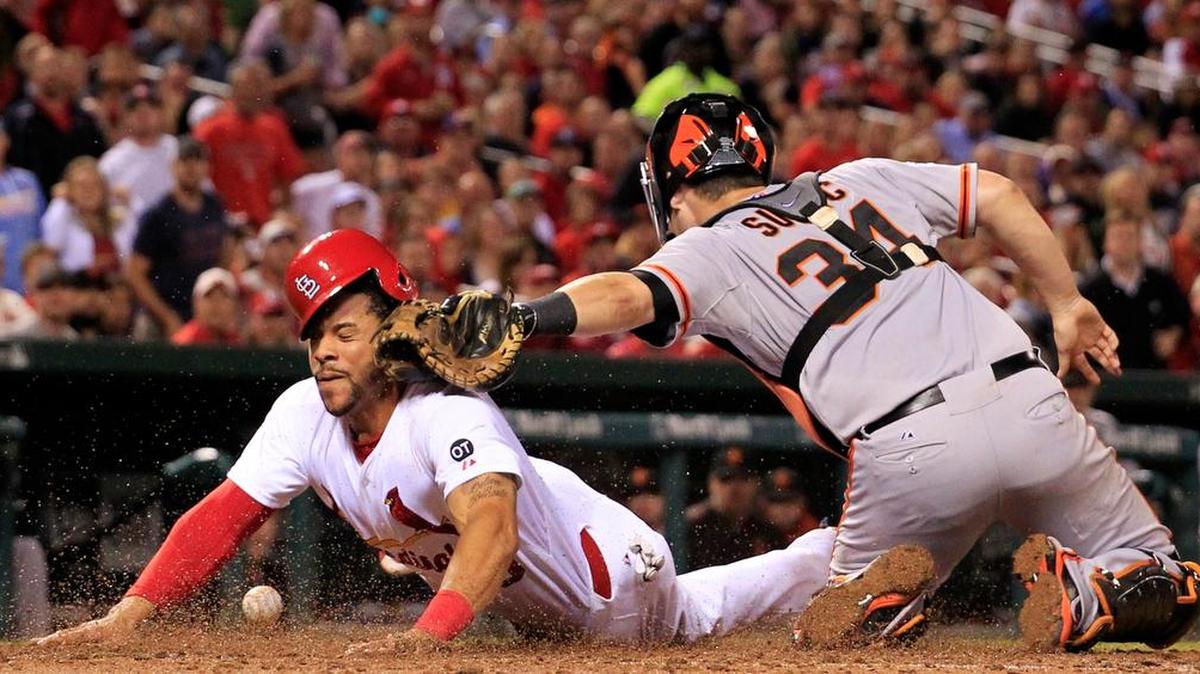 
The Cardinals’ Tommy Pham scores on a Matt Carpenter fielder’s choice as the ball eludes Giants catcher Andrew Susac during the seventh inning Wednesday at Busch Stadium.

