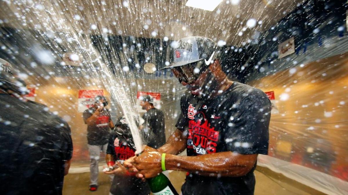 
St. Louis Cardinals' Jason Heyward pops the cork on a bottle of champagne after the Cardinals clinched the Central Division with an 11-1 win over the Pittsburgh Pirates in a baseball game in Pittsburgh, Wednesday, Sept. 30, 2015.
