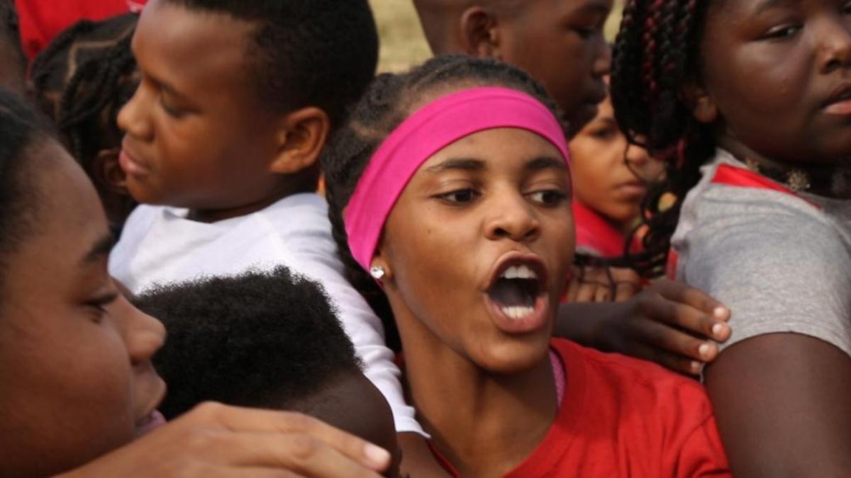 Onyka Handy, an 8th Grader Mason/Clark Middle School, leads the cross country team cheer after practice on Wednesday at Frank Holten Park. This East St. Louis cross country team consists of 112 students signed up, which is about a third of the middle school’s student population.