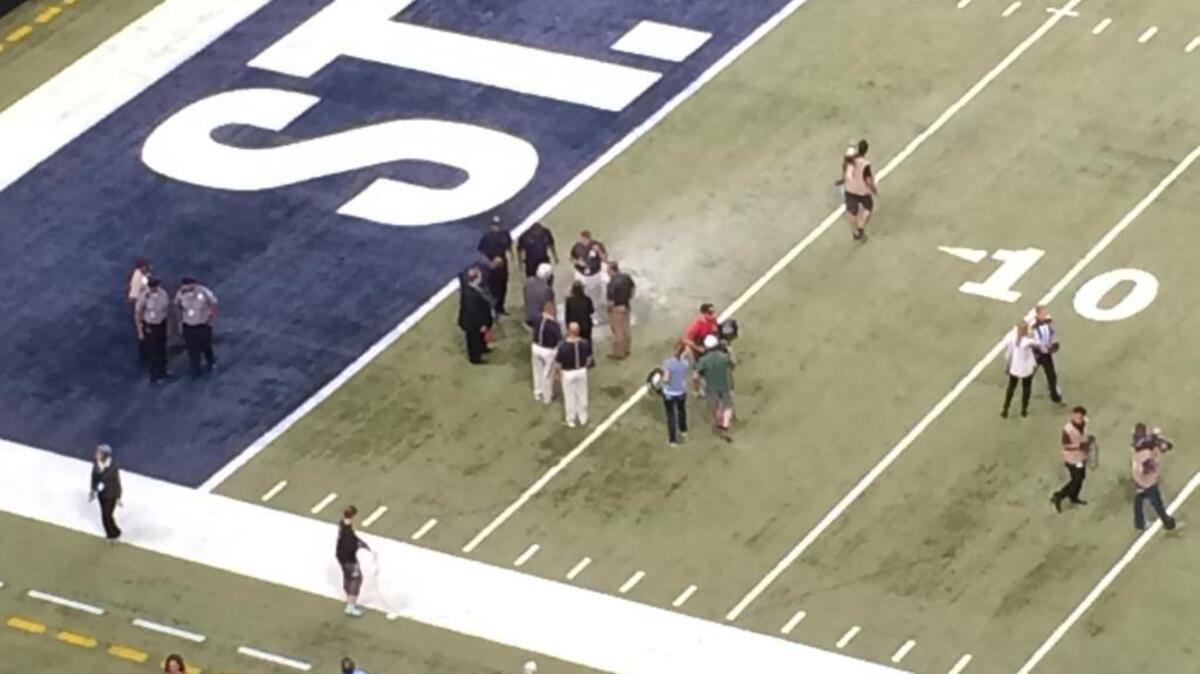 
Stadium officials checking the Edward Jones Dome after a fire during pregame introductions
