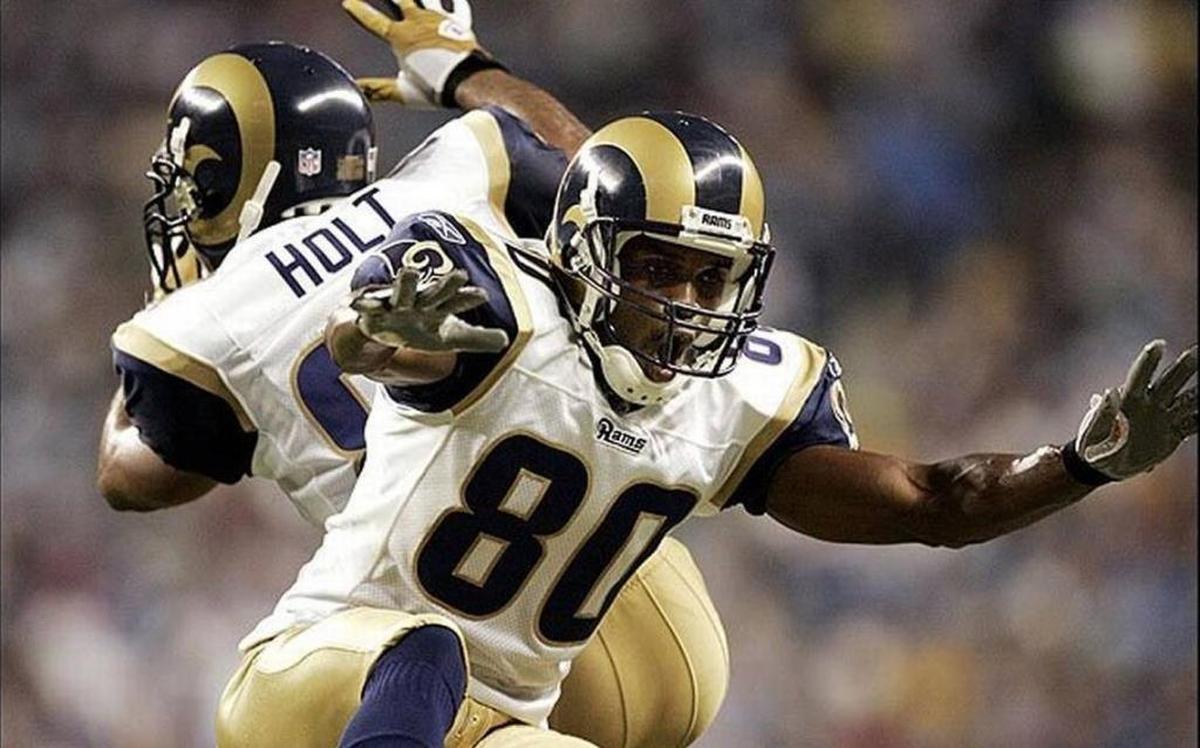 Isaac Bruce celebrates another St. Louis Rams touchdown with fellow wide receiver and Greatest Show on Turf teammate Torry Holt. In his latest column, Terry Mackin of the Belleville News-Democrat writes about the NFL and how he wishes St. Louis still had a team, among other football related topics.