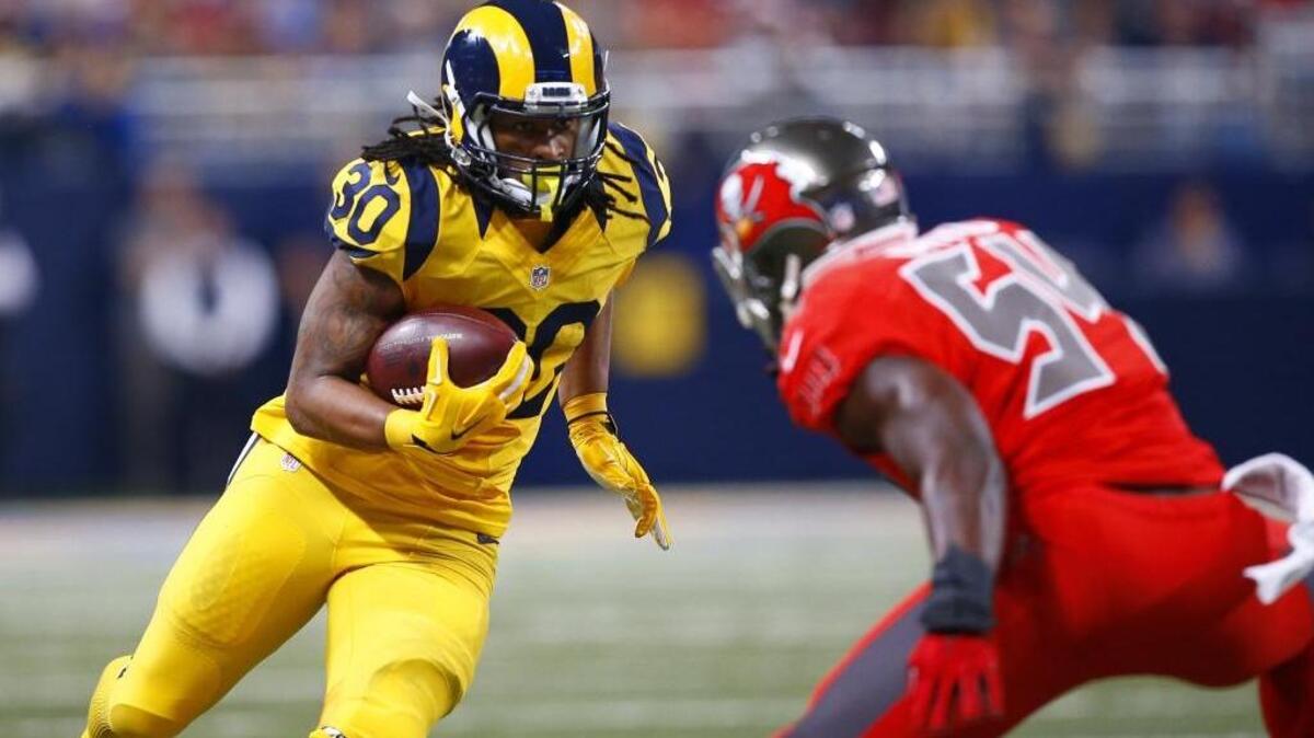 Rams running back Todd Gurley, left, runs againstTampa Bay linebacker Lavonte David Thursday. (AP Photo/Billy Hurst)