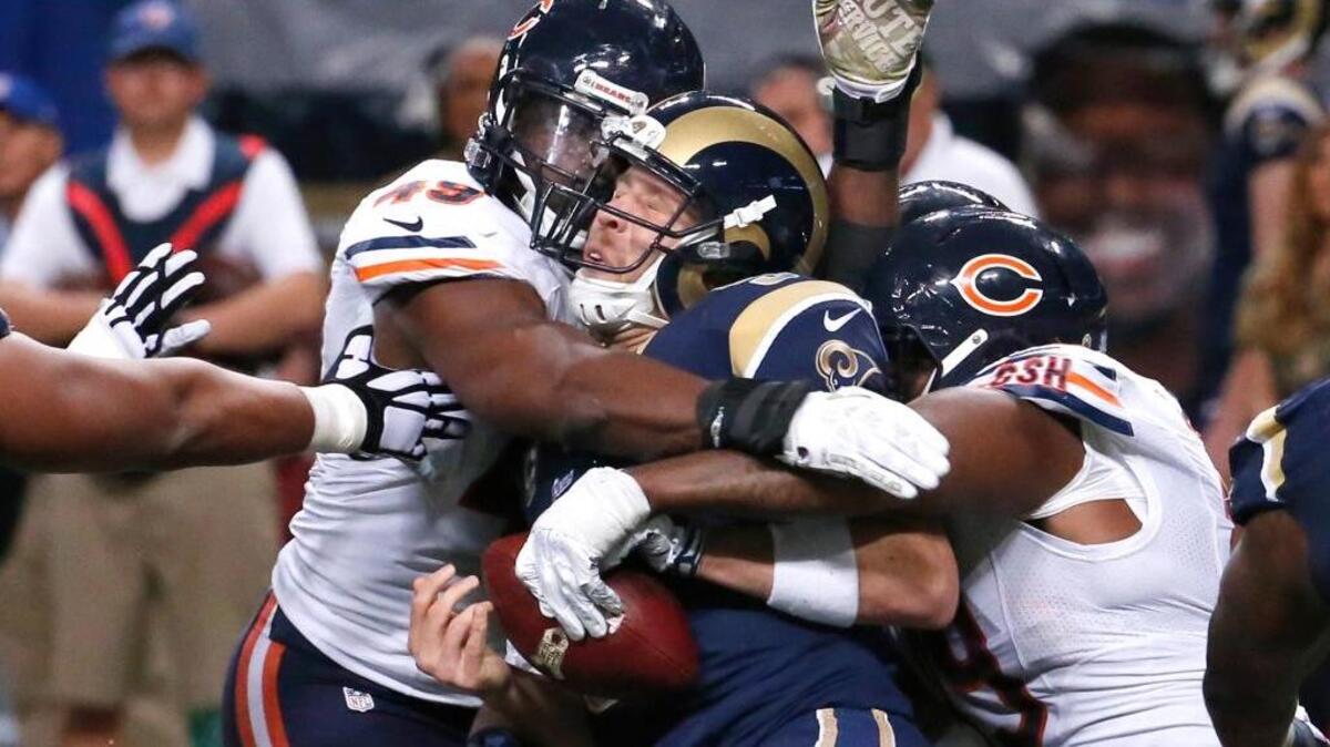 Chicago Bears outside linebacker Sam Acho (49), nose tackle Eddie Goldman (91) and linebacker Lamarr Houston (99) sack St. Louis Rams quarterback Nick Foles (5) during the fourth quarter on Sunday. (Jose M. Osorio/Chicago Tribune/TNS)