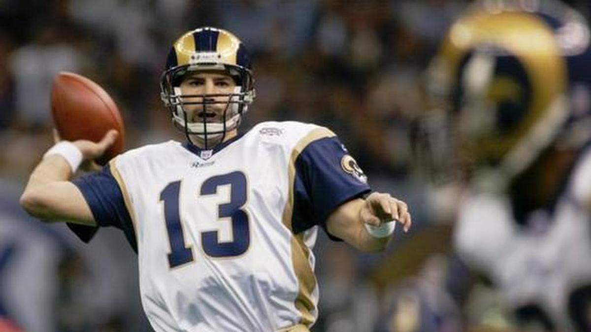 FILE - In this Feb. 3, 2002, file photo, St. Louis Rams quarterback Kurt Warner looks to pass to Marshall Faulk, right, in the first quarter against the New England Patriots in Super Bowl 36 in New Orleans. Warner is part of seven-man class heading into the Pro Football Hall of Fame, it was announced Saturday, Feb. 4, 2017.