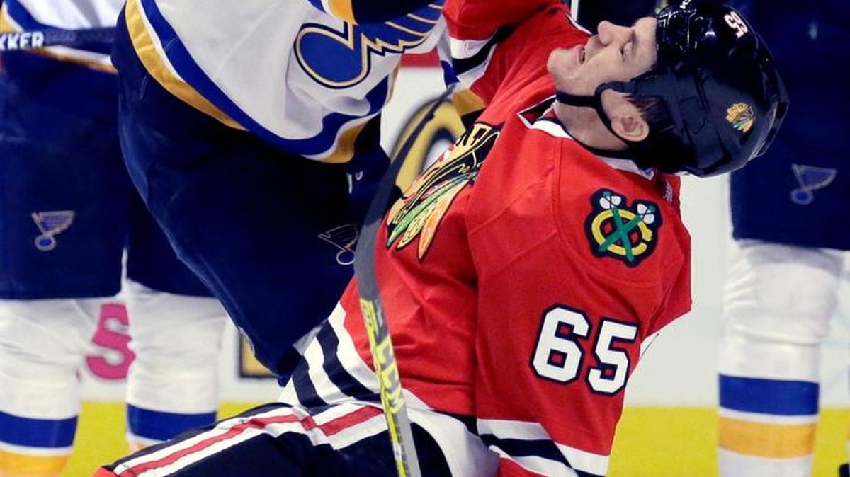 Blackhawks forwardAndrew Shaw (65) gets knocked down by Blues forward Troy Brouwer (36) during the Blues’ Game 4 victory Tuesday in Chicago. (AP Photo/Nam Y. Huh)