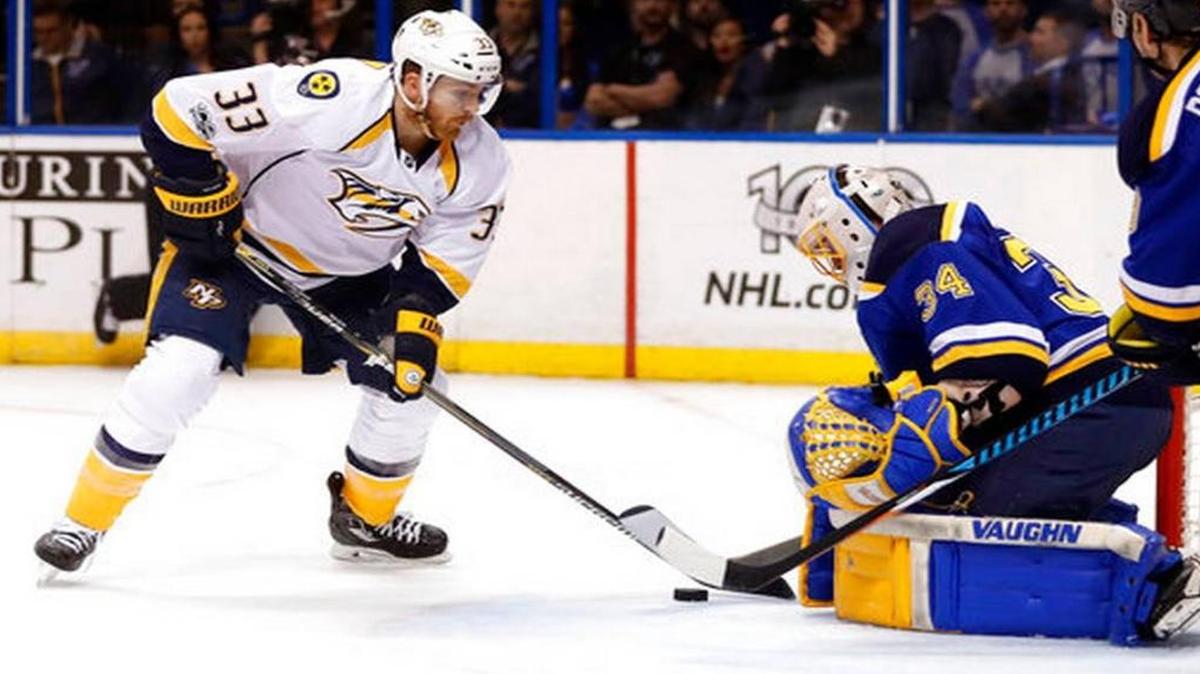 Nashville Predators' Colin Wilson, left, reaches for the puck as St. Louis Blues goalie Jake Allen defends during the first period in Game 1 of an NHL hockey second-round playoff series, Wednesday, April 26, 2017, in St. Louis.
