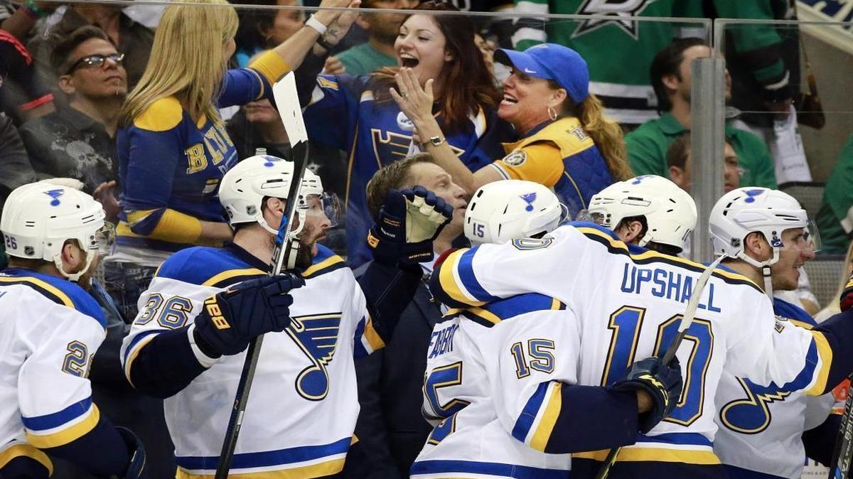 The St. Louis Blues' bench celebrates along wth their fans after Patrik Berglund (21) scored the third goal against the Dallas Stars in the first period during Game 7 on Wednesday.