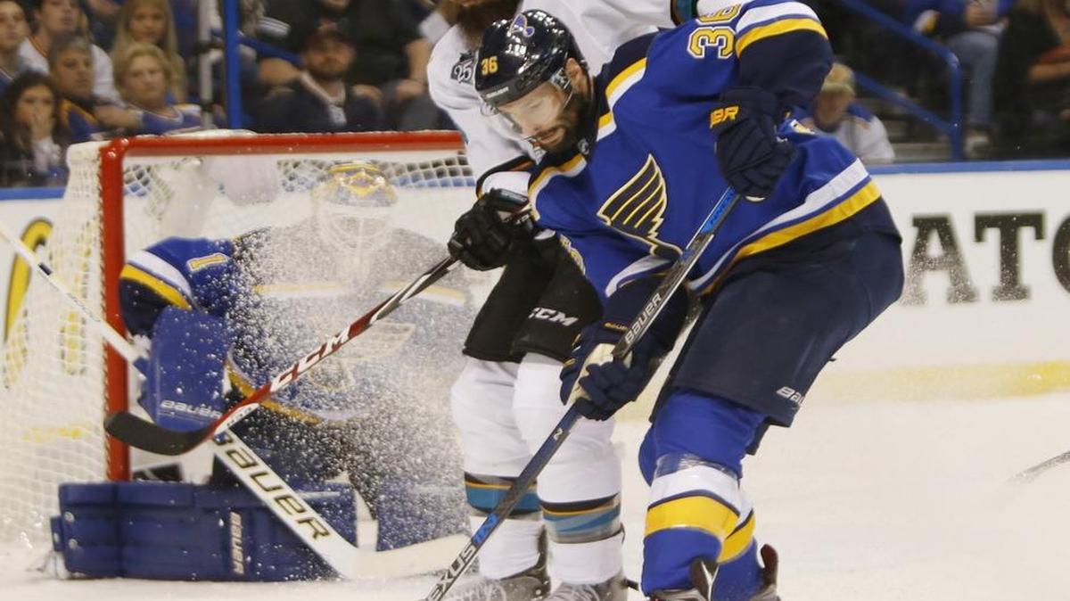 San Jose’s Brent Burns, top, battles for the puck against the Blues’ Troy Brouwer (36) in the first period in Game 2 on Tuesday.