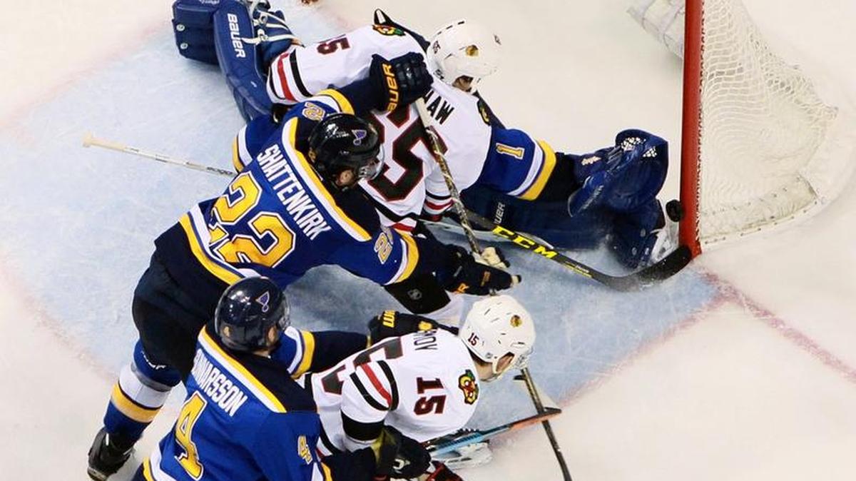 Blackhawks winger Andrew Shaw (65) scores past Blues goaltender Brian Elliott as he takes a shove from Blues defenseman Kevin Shattenkirk during the third period of Game 2 on Friday. The Blackhawks won 3-2 to even the first-round playoff series at a game apiece.