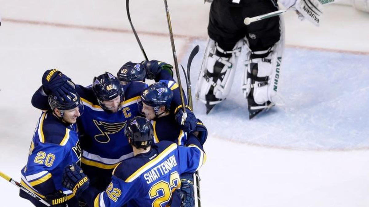 St. Louis Blues captain David Backes, (42) is congratulated by teammates after scoring past Dallas Stars goalie Antti Niemi (31) during the first period of Game 3. (AP Photo/Jeff Roberson)