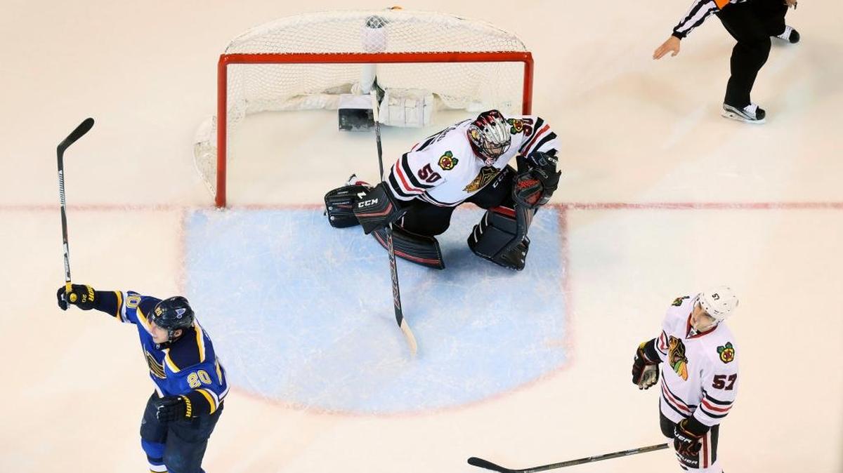 Blues left wing Alexander Steen, left, reacts after teammate David Backes scored the lone goal of the game on a deflection off Blackhawks defenseman Trevor van Riemsdyk, right, that went past Blackhawks goaltender Corey Crawford in overtime of Game 1 of an NHL hockey Stanley Cup first-round playoff series, Wednesday, April 13, 2016, in St. Louis.