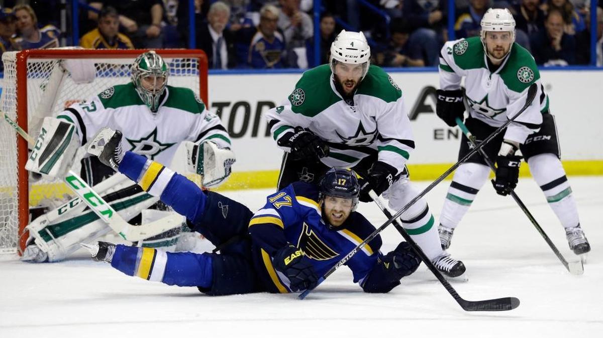 St. Louis’ Jaden Schwartz falls while reaching for a puck as Dallas Stars goalie Kari Lehtonen, Jason Demers and Kris Russell watch Monday during the second period of Game 6 of the Western Conference semifinals in St. Louis.