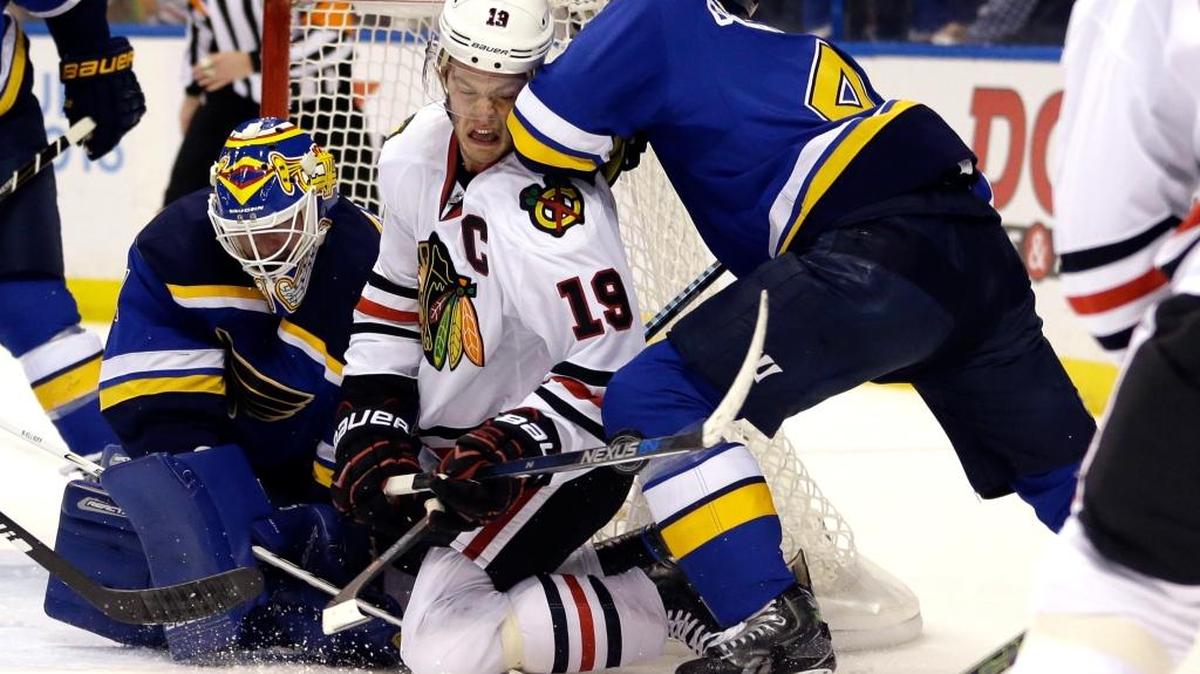 Chicago Blackhawks’ Jonathan Toews, center, is checked by St. Louis Blues' Carl Gunnarsson and goalie Brian Elliott, left, during the first period of Game 1 on Wednesday. (AP Photo/Jeff Roberson)