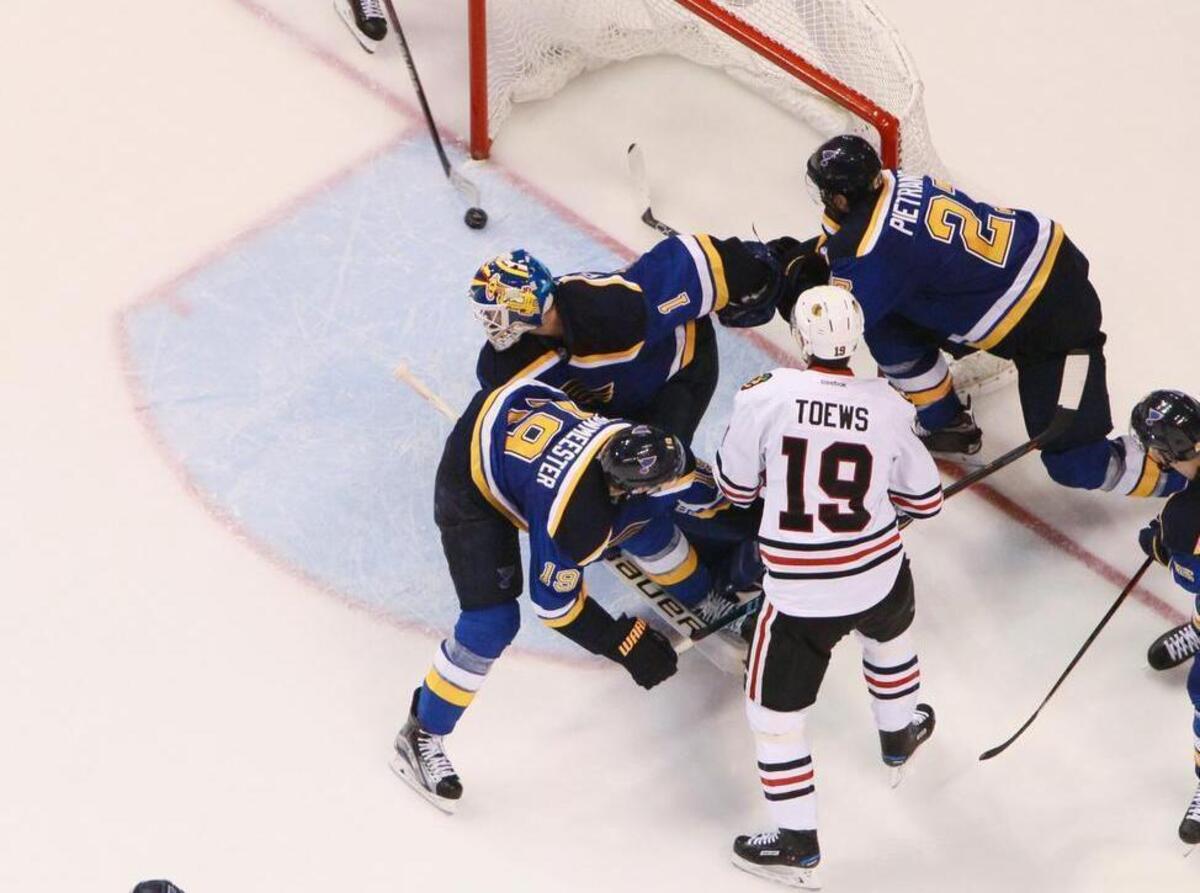 Chicago Blackhawks right wing Patrick Kane (top) scores the game-winning goal on a wrap-around shot past St. Louis Blues goaltender Brian Elliott in the second overtime during Game 5 of a Western Conference quarterfinal playoff game between the St. Louis Blues and the Chicago Blackhawks early on Friday, April 22, 2016, at the Scottrade Center in St. Louis. The game began the previous evening on Thursday, April 21, 2016. The Blackhawks won 4-3.
