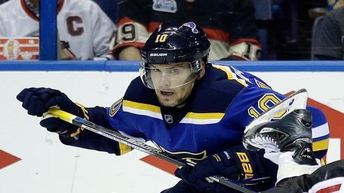 Chicago Blackhawks' Andrew Shaw, right, is sent flying after colliding with St. Louis Blues' Scottie Upshall while reaching for a puck during the first round of the playoffs. Upshall signed a one-year deal with the Blues on Wednesday.