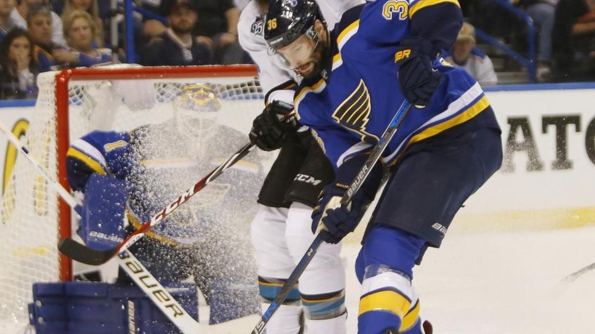 The San Jose Sharks' Brent Burns, top, battles for the puck against the St. Louis Blues' Troy Brouwer (36) in the first period in Game 2.