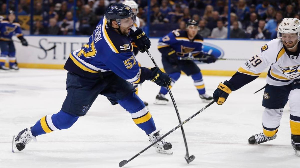 St. Louis Blues left wing David Perron (57) shoots as he is defended by Nashville Predators defenseman Roman Josi (59), of Switzerland, during the second period in Game 2 of an NHL hockey second-round playoff series Friday, April 28, 2017, in St. Louis.