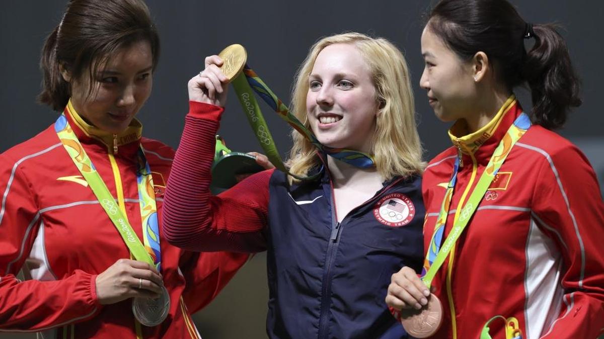 Virginia Thrasher, center, of the United States holds her gold medal for the women’s 10-meter air rifle competition during the award ceremony with the runner-up Du li, left, of China and third place Yi Siling, right, of China at Olympic Shooting Center at the 2016 Summer Olympics in Rio de Janeiro, Brazil, Saturday, Aug. 6, 2016.