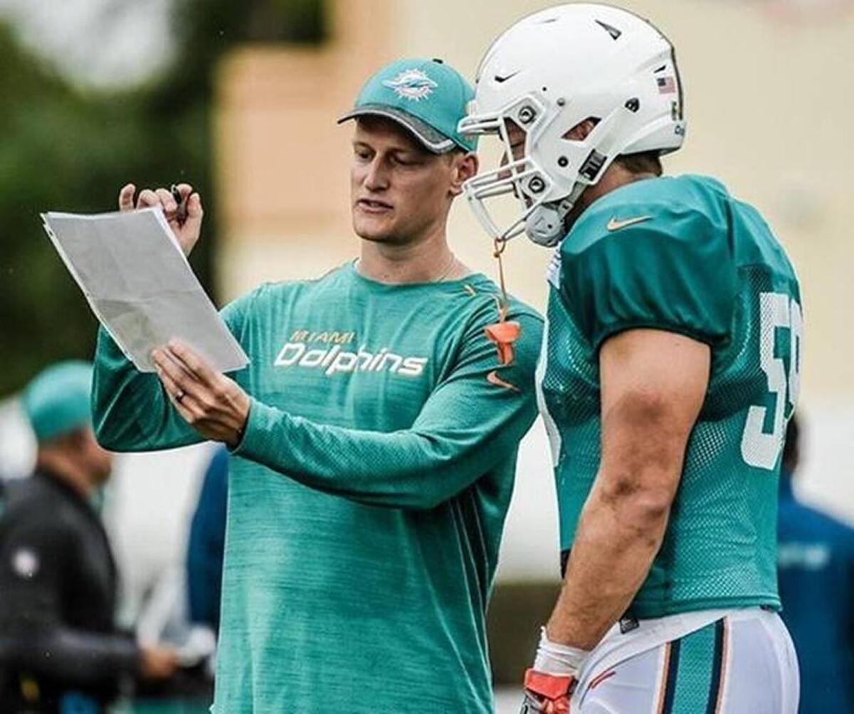 Belleville East graduate Chase Allen, shown here with a coach during Miami Dolphins’ training camp, said he learned he made the NFL team’s 53-man roster by the phone call he didn’t get last Saturday.
